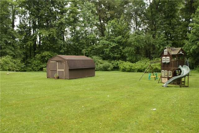 130 Hall Rd, Findley Twp, PA 16137 - view of grassy yard with a storage shed, a playground, and view of wooded area