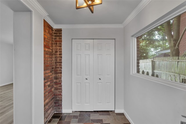 494 Highview Rd, Baldwin Twp, PA 15228 - entryway featuring brick wall, crown molding, and stone finish flooring