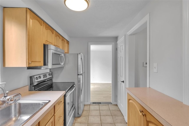 494 Highview Rd, Baldwin Twp, PA 15228 - kitchen featuring stainless steel appliances, light countertops, light tile patterned floors, and light brown cabinetry