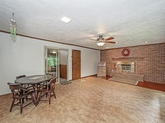 2665 Warrendale Bayne Rd, Marshall, PA 15005 - dining area featuring a ceiling fan, crown molding, carpet flooring, a fireplace, and a textured ceiling