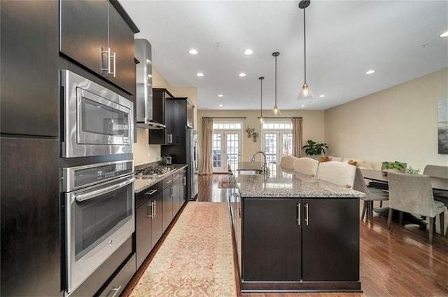 323 Osona Ln, Marshall, PA 16046 - kitchen with stainless steel appliances, wall chimney exhaust hood, wood finished floors, a kitchen island with sink, and recessed lighting