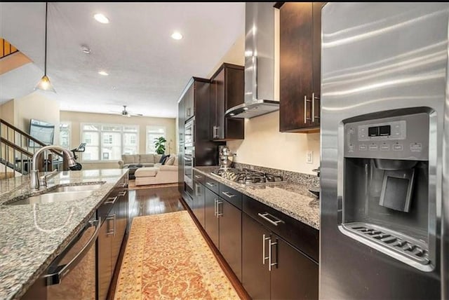 323 Osona Ln, Marshall, PA 16046 - kitchen featuring stainless steel appliances, wall chimney range hood, ceiling fan, open floor plan, and dark wood finished floors