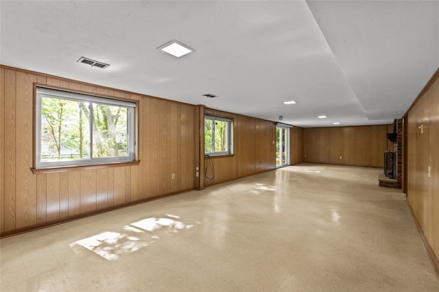103 Drood Ln, Ross Twp, PA 15237 - spare room with wooden walls, a brick fireplace, and light flooring