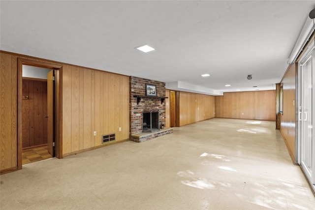 103 Drood Ln, Ross Twp, PA 15237 - unfurnished living room featuring wood walls and a brick fireplace