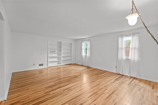 103 Drood Ln, Ross Twp, PA 15237 - unfurnished room with healthy amount of natural light, built in features, and light wood-style floors