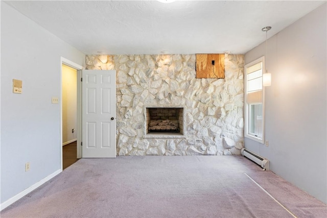 130 Clare Dr, South Strabane, PA 15301 - unfurnished living room featuring baseboard heating, carpet flooring, and a stone fireplace