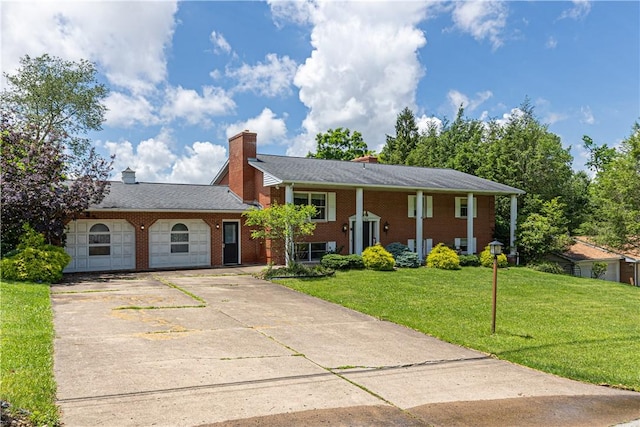 130 Clare Dr, South Strabane, PA 15301 - view of front of home with a front yard, brick siding, driveway, and a chimney