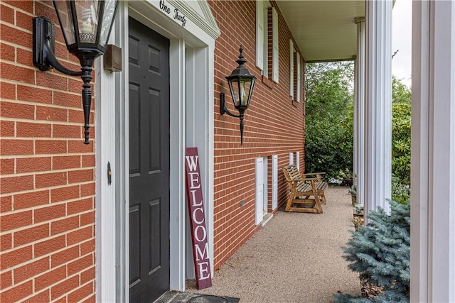 130 Clare Dr, South Strabane, PA 15301 - doorway to property featuring brick siding and covered porch