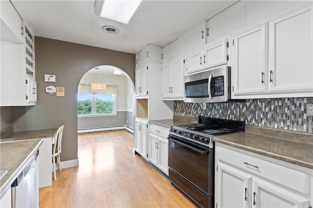130 Clare Dr, South Strabane, PA 15301 - kitchen with appliances with stainless steel finishes, baseboard heating, white cabinetry, and decorative backsplash