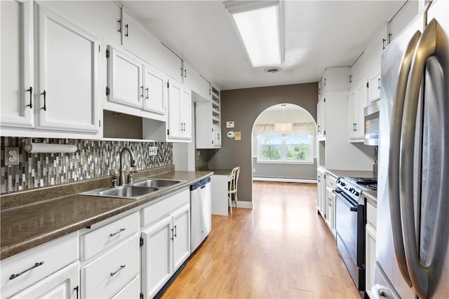 130 Clare Dr, South Strabane, PA 15301 - kitchen featuring appliances with stainless steel finishes, white cabinetry, a baseboard radiator, light wood-style floors, and tasteful backsplash