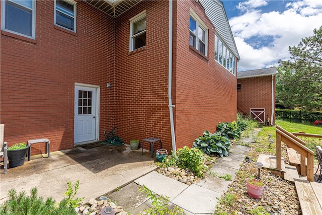 130 Clare Dr, South Strabane, PA 15301 - view of side of property with brick siding and a patio area