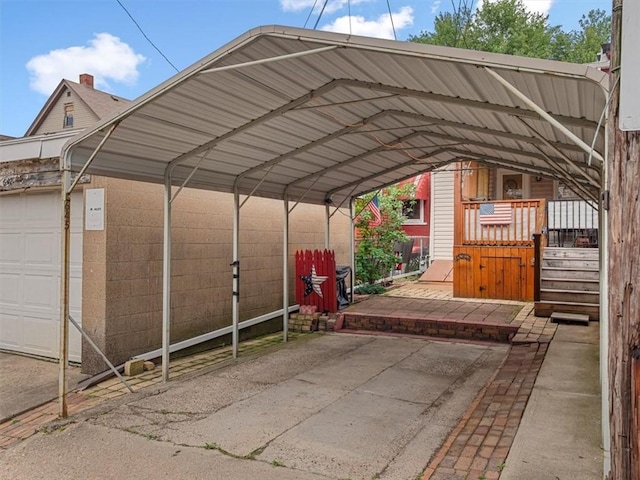 view of parking with a detached carport and a garage