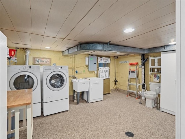 laundry area with independent washer and dryer, electric panel, and recessed lighting