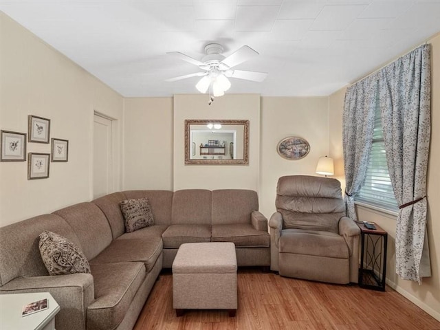 living area featuring ceiling fan and wood finished floors
