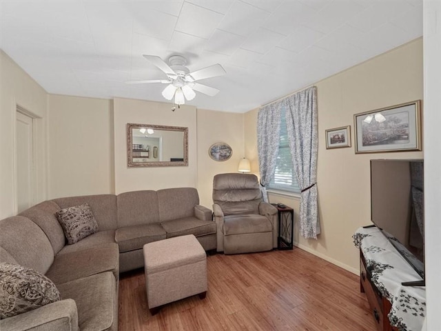 living room with light wood-style floors and ceiling fan