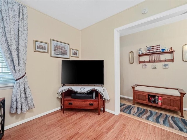 living area with wood finished floors and baseboards