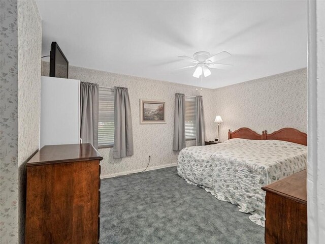 bedroom with carpet floors, wallpapered walls, and ceiling fan