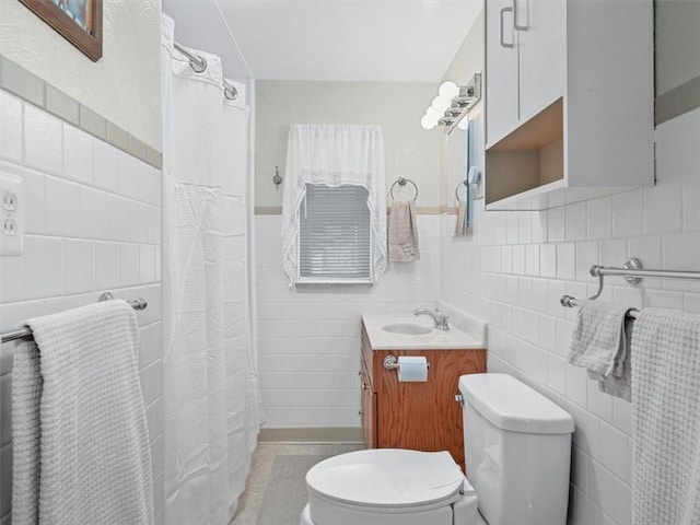 bathroom with tile walls, vanity, and a shower with shower curtain