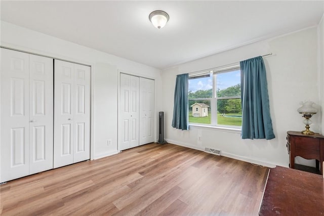 135 Preacher Rd, East Huntingdon, PA 15639 - unfurnished bedroom with multiple closets and light wood-style flooring
