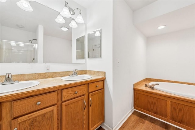 135 Preacher Rd, East Huntingdon, PA 15639 - bathroom with a stall shower, double vanity, a bath, and wood finished floors