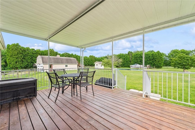 135 Preacher Rd, East Huntingdon, PA 15639 - wooden deck featuring a lawn, outdoor dining area, view of wooded area, and a shed