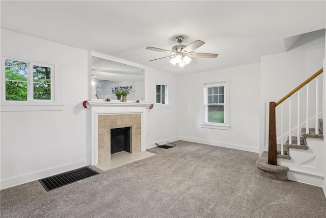 1571 Baldwick Rd, Banksville/Westwood, PA 15205 - unfurnished living room featuring carpet flooring, stairway, a tiled fireplace, and a ceiling fan