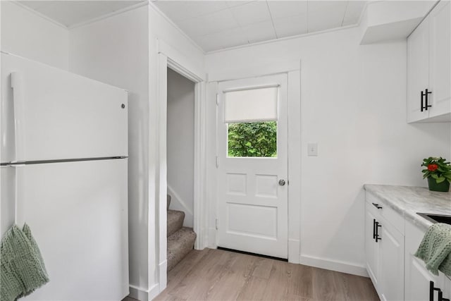 1571 Baldwick Rd, Banksville/Westwood, PA 15205 - kitchen with freestanding refrigerator, light wood-style flooring, white cabinets, and light countertops