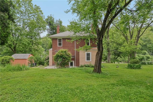 1571 Baldwick Rd, Banksville/Westwood, PA 15205 - view of side of home with a chimney, a yard, brick siding, and a storage unit
