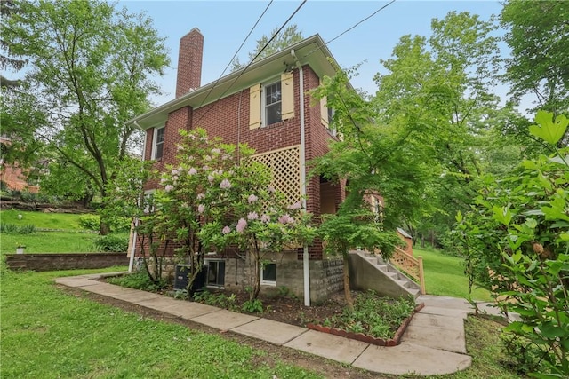 1571 Baldwick Rd, Banksville/Westwood, PA 15205 - view of side of home featuring a chimney, a yard, stairway, and brick siding