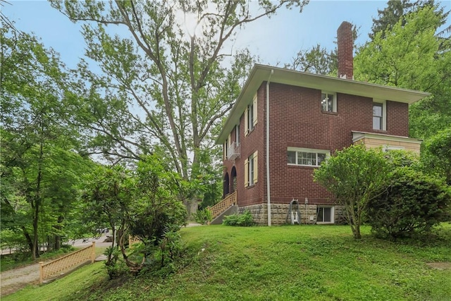 1571 Baldwick Rd, Banksville/Westwood, PA 15205 - view of side of property with a chimney, brick siding, a lawn, and stairs
