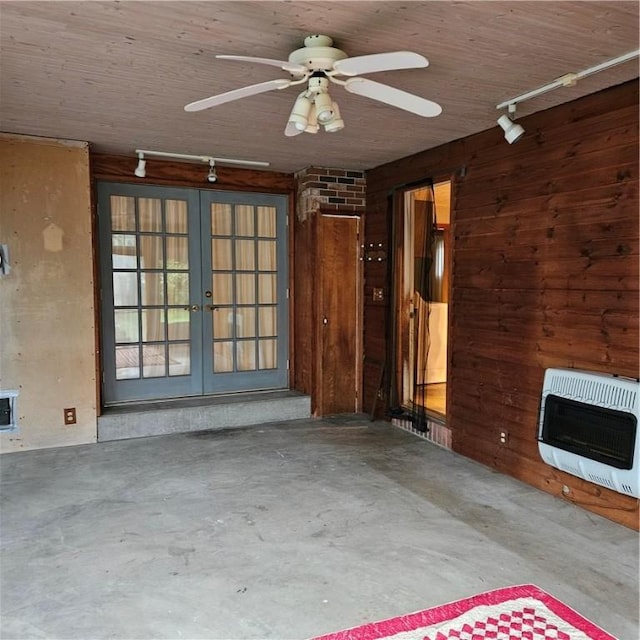 111 Laughlin St, Dawson, PA 15428 - unfurnished living room with heating unit, track lighting, french doors, wooden walls, and concrete floors