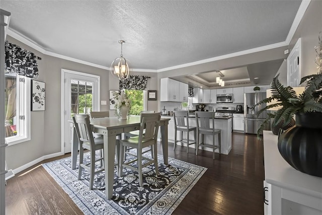1008 Aspen Dr, Findlay Twp, PA 15126 - dining area featuring ornamental molding, dark wood finished floors, a tray ceiling, a chandelier, and a textured ceiling