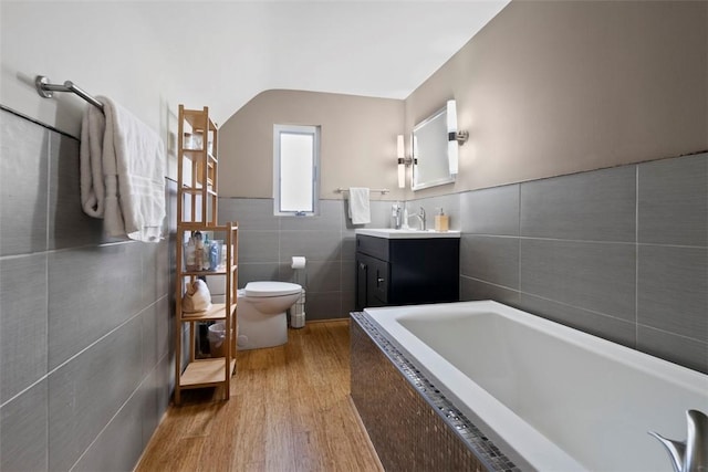 36 Warriors Rd, Green Tree, PA 15205 - full bathroom with tile walls, tiled tub, vanity, and wood finished floors