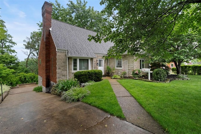 36 Warriors Rd, Green Tree, PA 15205 - view of front facade with stone siding, roof with shingles, a chimney, and a front yard
