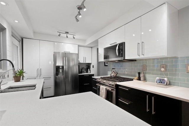 36 Warriors Rd, Green Tree, PA 15205 - kitchen with appliances with stainless steel finishes, modern cabinets, light countertops, white cabinets, and decorative backsplash