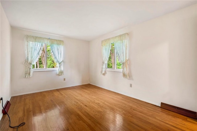 100 Laurel Hill Dr, Pine Twp Nal, PA 15090 - empty room featuring healthy amount of natural light, hardwood / wood-style floors, and a baseboard radiator