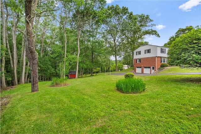 100 Laurel Hill Dr, Pine Twp Nal, PA 15090 - view of grassy yard featuring a garage and asphalt driveway