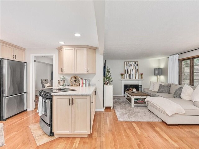 212 Timber Ln, Aleppo Nal, PA 15143 - kitchen featuring stainless steel appliances, light countertops, open floor plan, recessed lighting, and light wood-style flooring