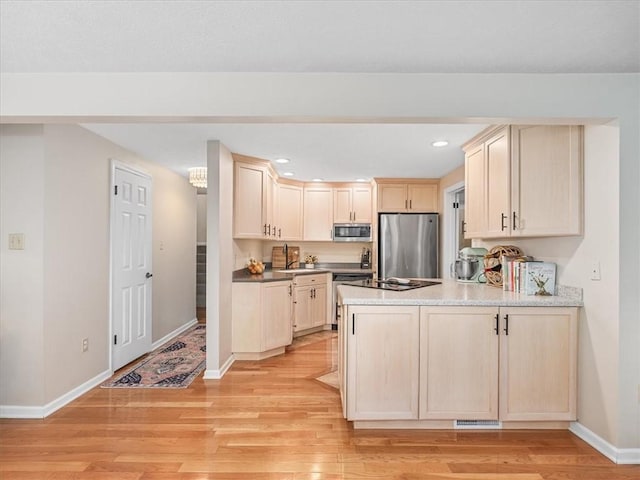 212 Timber Ln, Aleppo Nal, PA 15143 - kitchen featuring stainless steel appliances, a peninsula, light brown cabinets, light wood-style floors, and recessed lighting