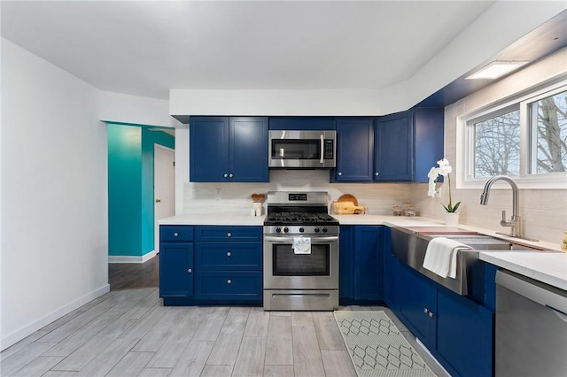 624 S Darby Rd, Hermitage, PA 16148 - kitchen featuring appliances with stainless steel finishes, blue cabinets, and backsplash