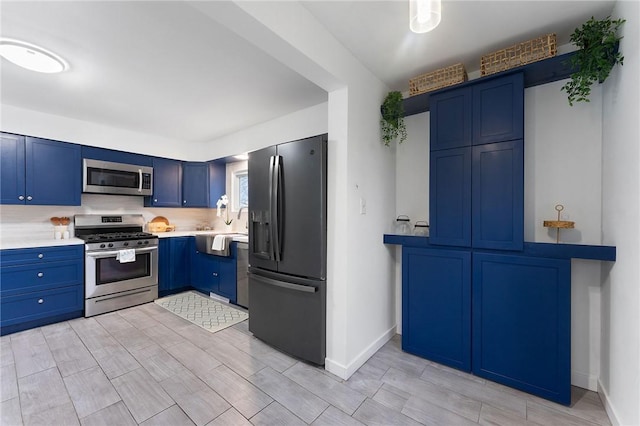 624 S Darby Rd, Hermitage, PA 16148 - kitchen with appliances with stainless steel finishes, blue cabinetry, light countertops, and wood finish floors