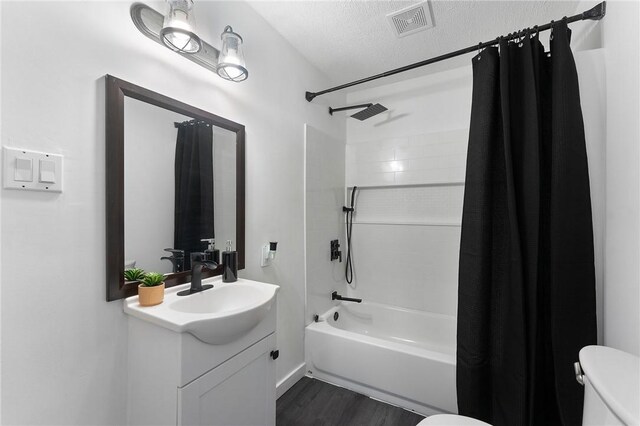 624 S Darby Rd, Hermitage, PA 16148 - bathroom featuring vanity, shower / bath combo, wood finished floors, and a textured ceiling