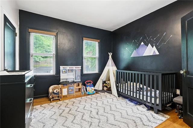 2740 Shelly St, South Side, PA 15203 - bedroom featuring wood finished floors and an accent wall