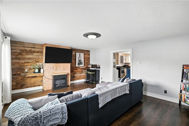 2740 Shelly St, South Side, PA 15203 - living area with wood finished floors, wooden walls, and a brick fireplace