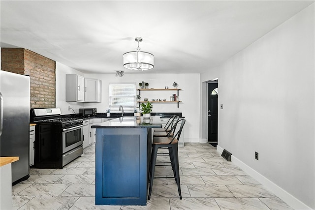 2740 Shelly St, South Side, PA 15203 - kitchen featuring stainless steel appliances, light marble finish floors, a kitchen breakfast bar, and pendant lighting