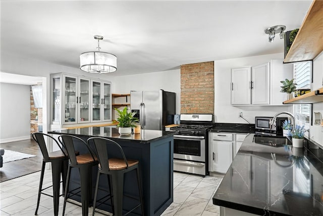 2740 Shelly St, South Side, PA 15203 - kitchen featuring stainless steel appliances, dark countertops, open shelves, white cabinetry, and a center island