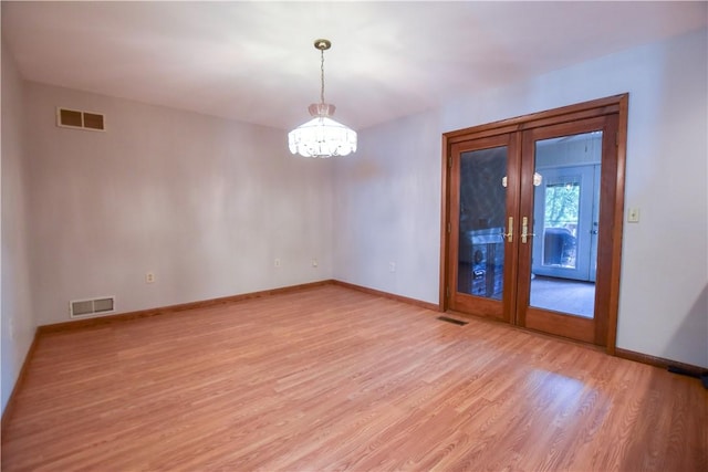 150 Morgan Rd, Penn Twp But, PA 16002 - spare room featuring light wood-type flooring, a chandelier, and french doors