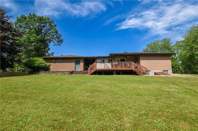 150 Morgan Rd, Penn Twp But, PA 16002 - back of property featuring brick siding, a wooden deck, and a lawn