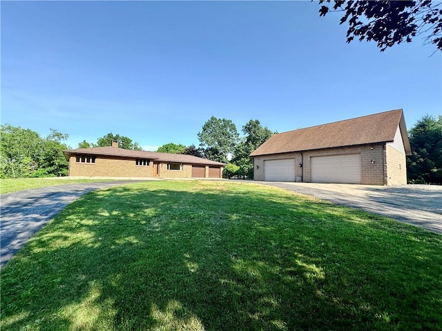 150 Morgan Rd, Penn Twp But, PA 16002 - single story home with a detached garage, brick siding, a front yard, a chimney, and an outbuilding