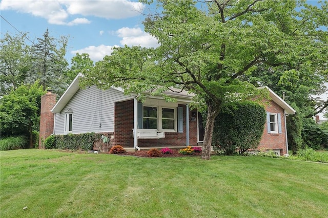1154 Bucknell, Monroeville, PA 15146 - view of front facade featuring brick siding, a front yard, and a chimney